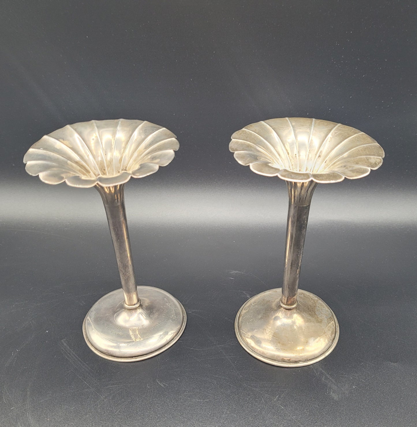 A very nice pair of sterling silver tulip posy vases, each set with fanned rims and graduated bases. With an inscription relating to a golfing competition.