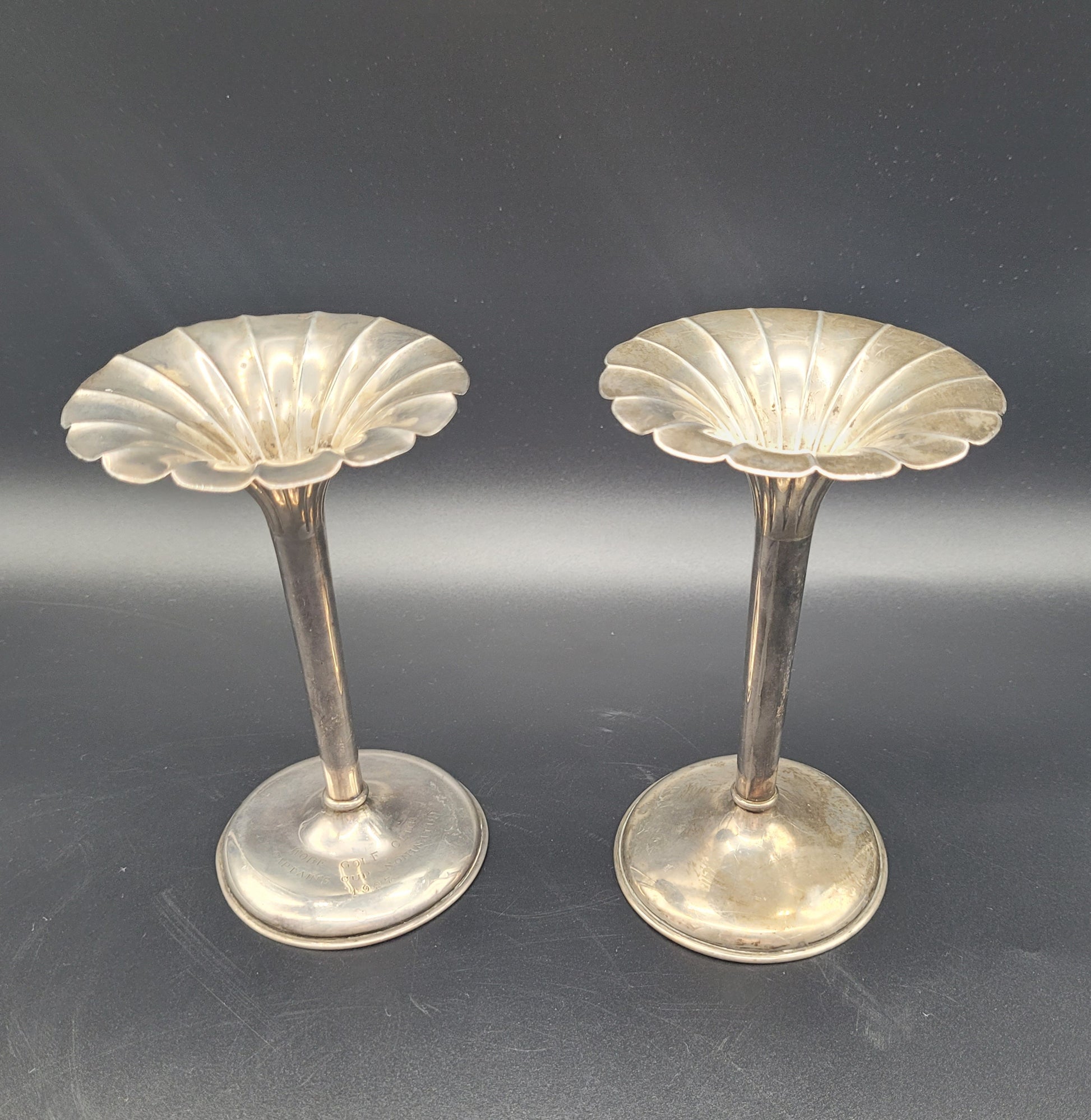A very nice pair of sterling silver tulip posy vases, each set with fanned rims and graduated bases. With an inscription relating to a golfing competition.