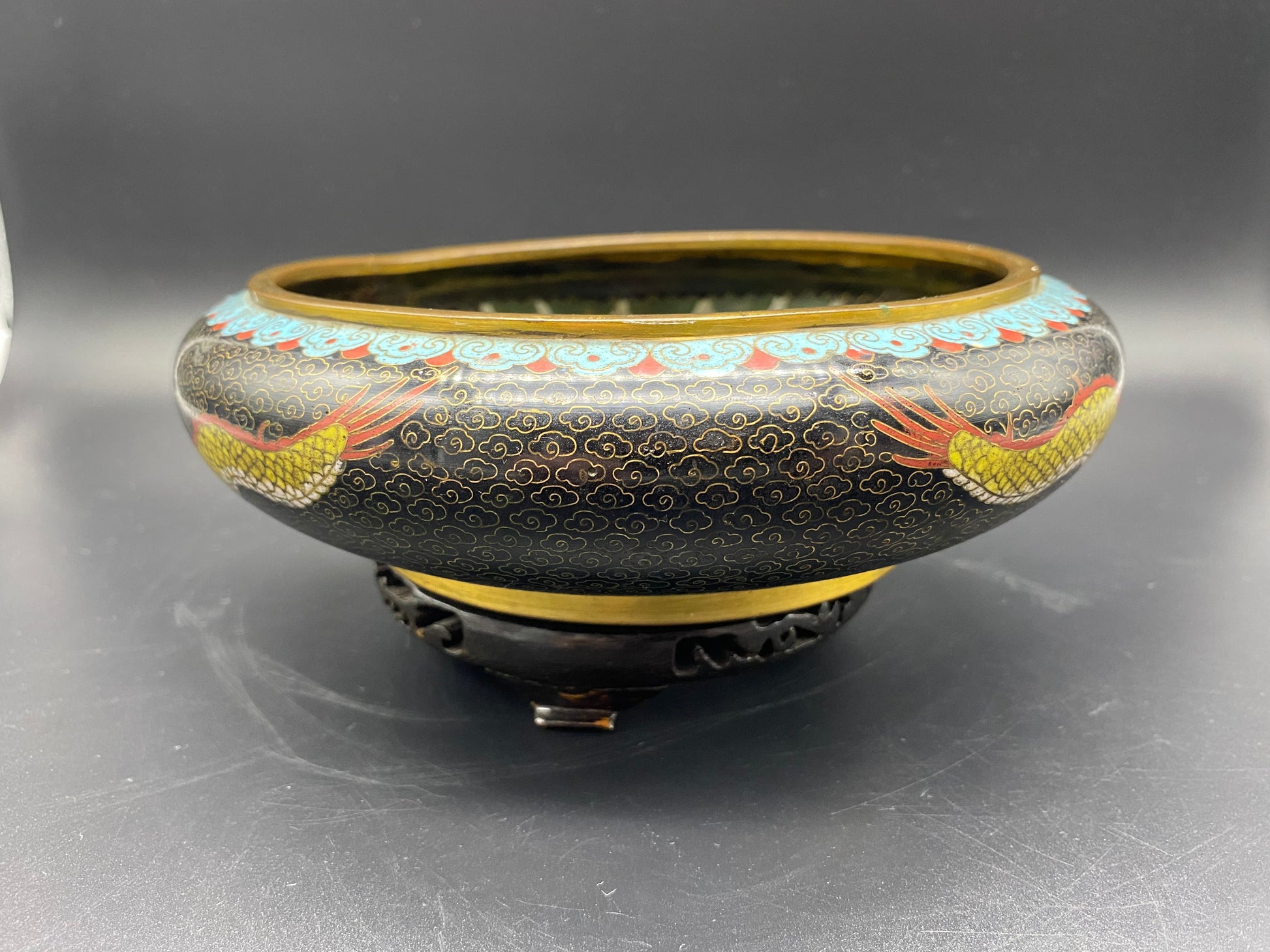 In champleve vases one most often finds one or more bands of design with areas of plain or etched metal separating them. In Cloisonné wares the enamel is contained within thin walls of metal that have been soldered to the surface of the metal vase