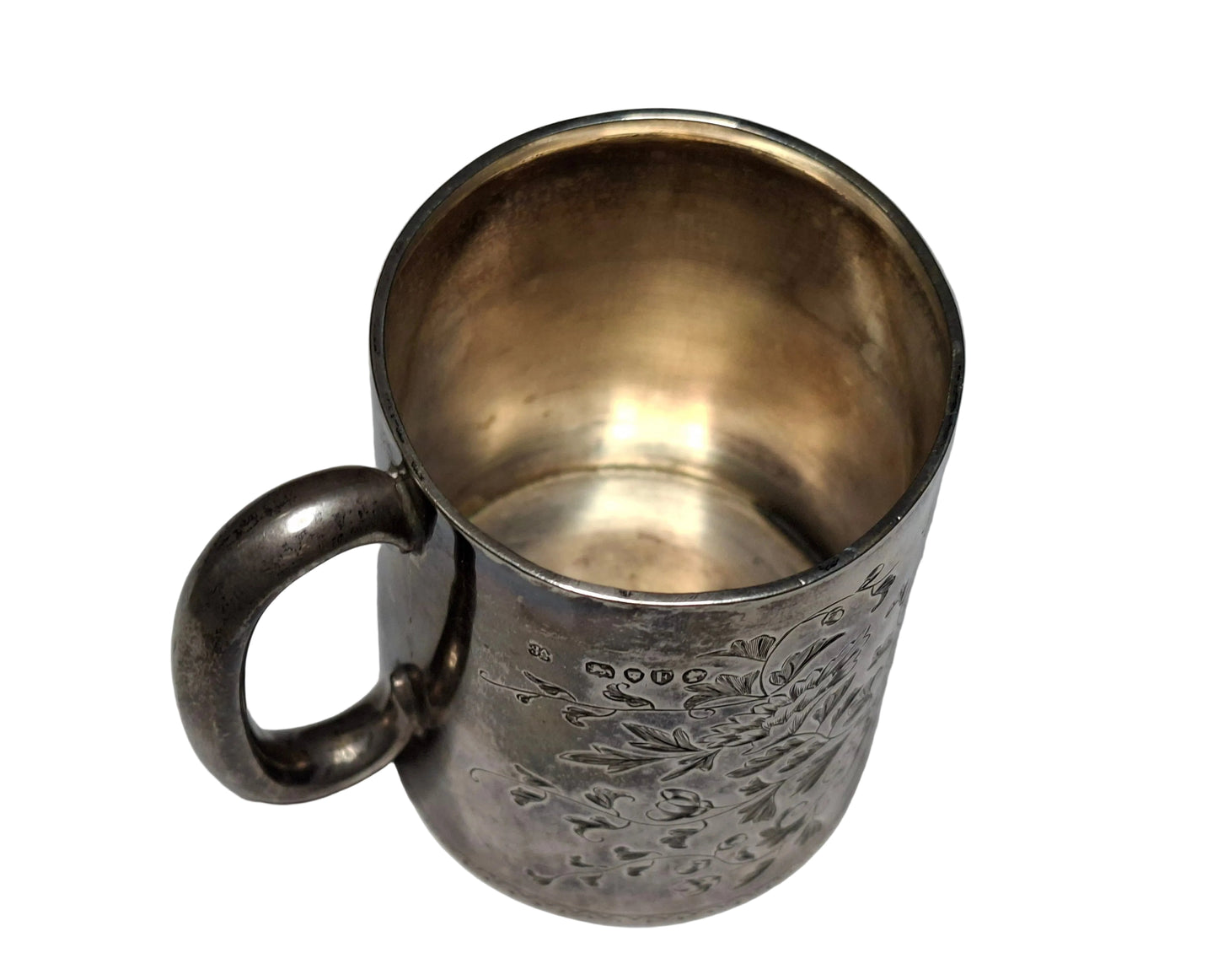 Silver mug with embossed design on a gray background