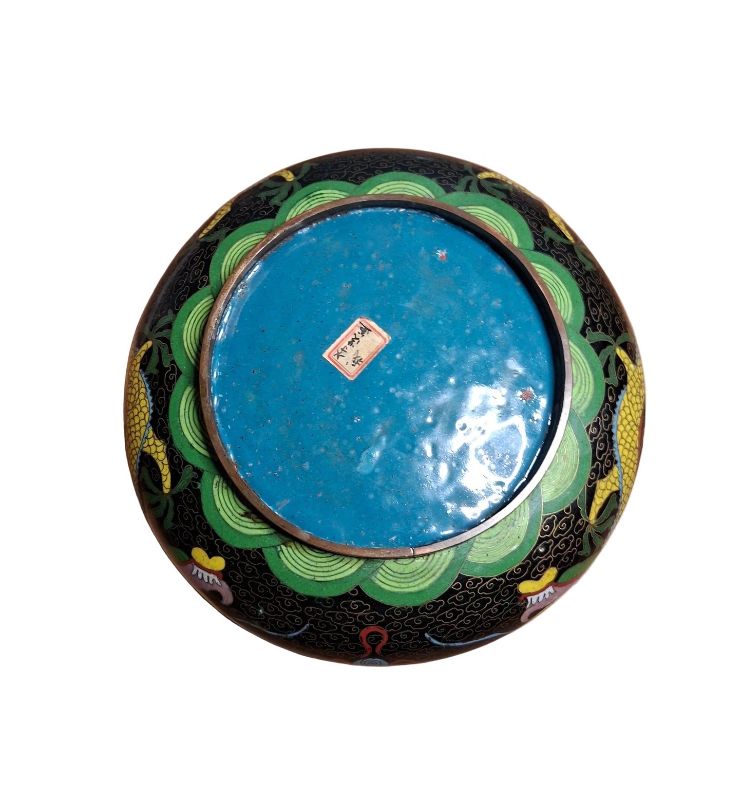 The bottom of a Chinese cloisonne low brass bowl with a dynamic dragon motif