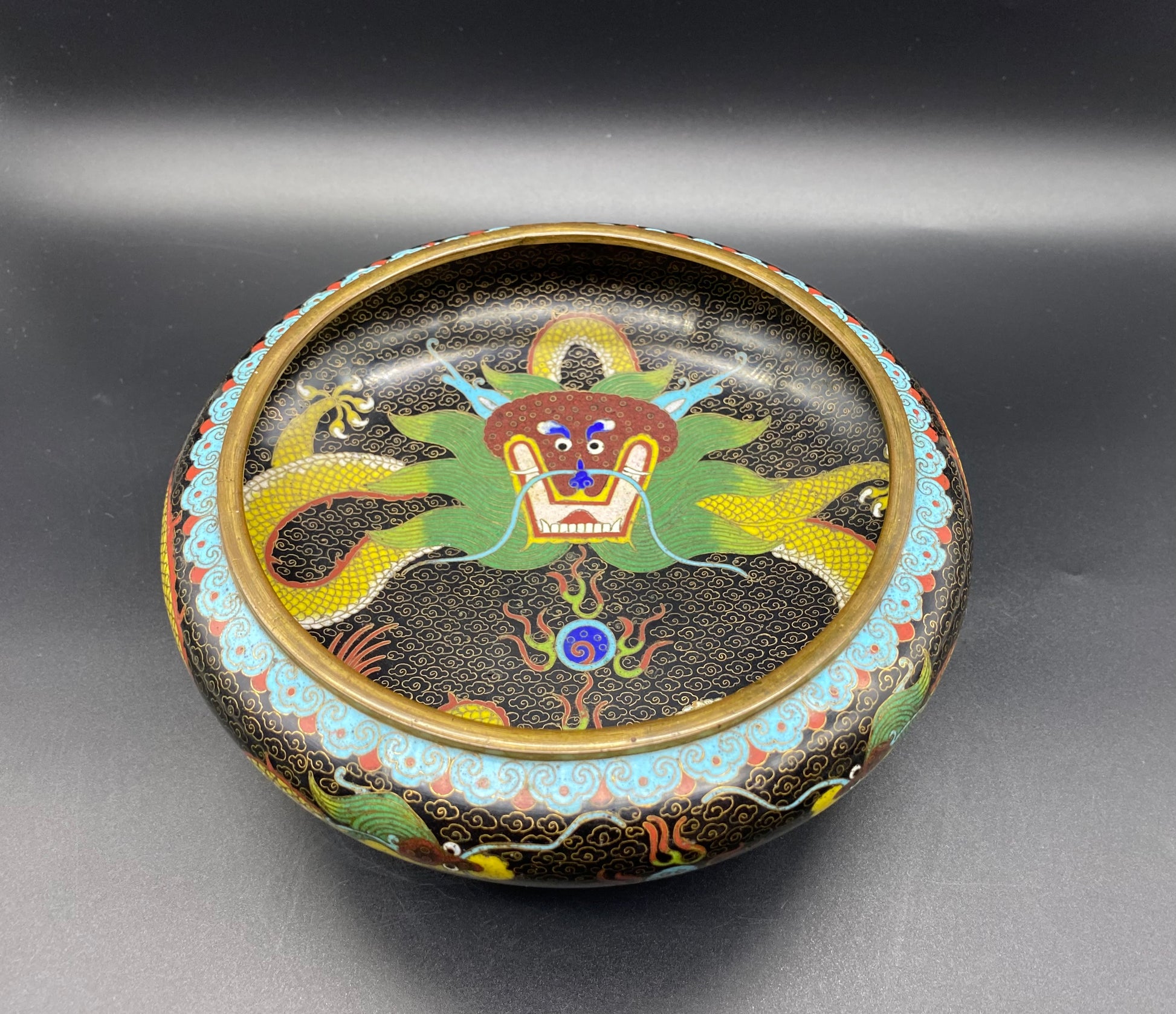 This is a fabulous antique Chinese Cloisonne Bowl it has a black ground covered all over with a cloud pattern. It also has a total of three colourful decorations of dragons. KB ANTIQUES & JEWELLERY 