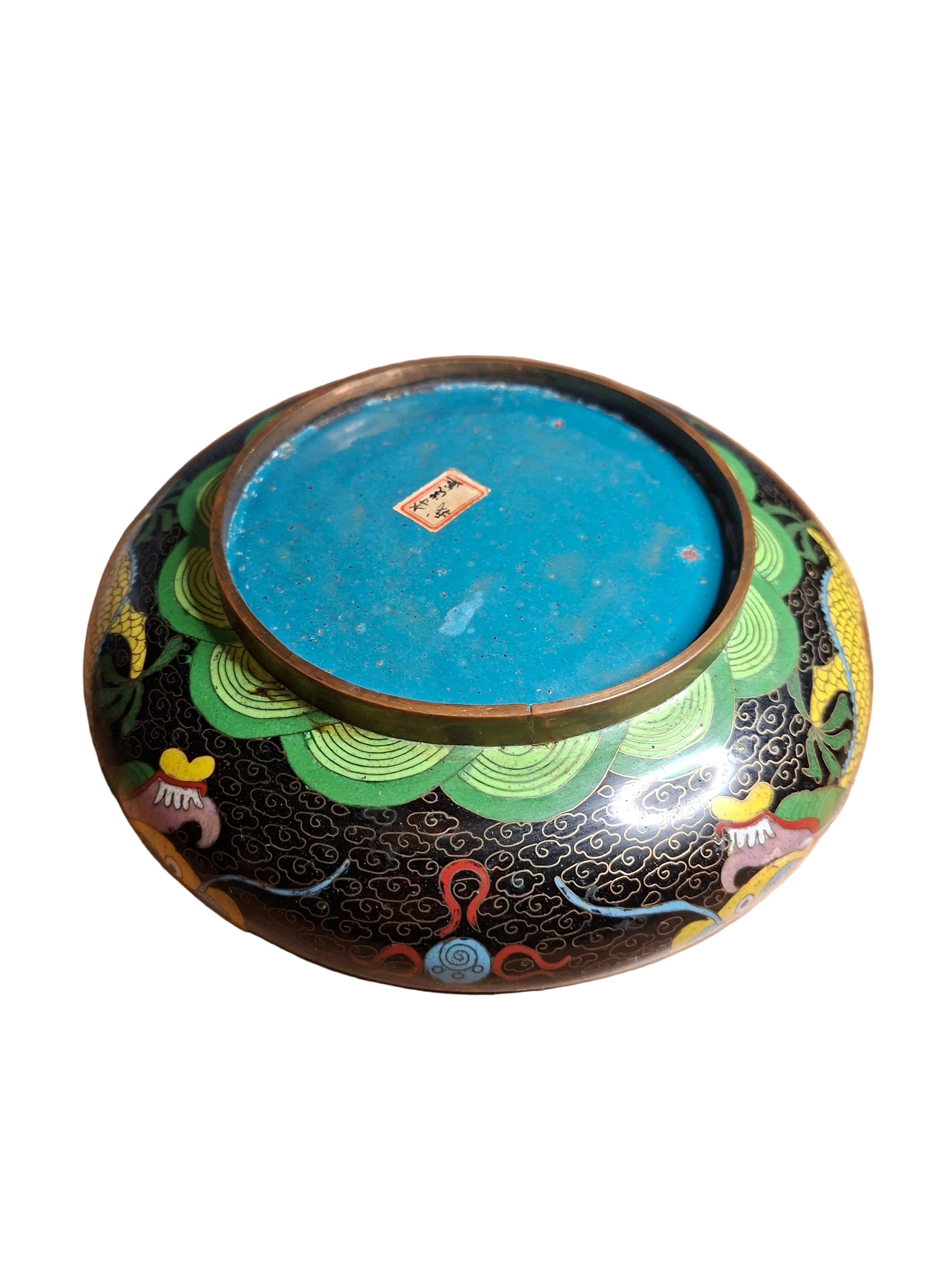 The back of a late qing dynasty cloisonne low brass bowl with a dynamic dragon motif
