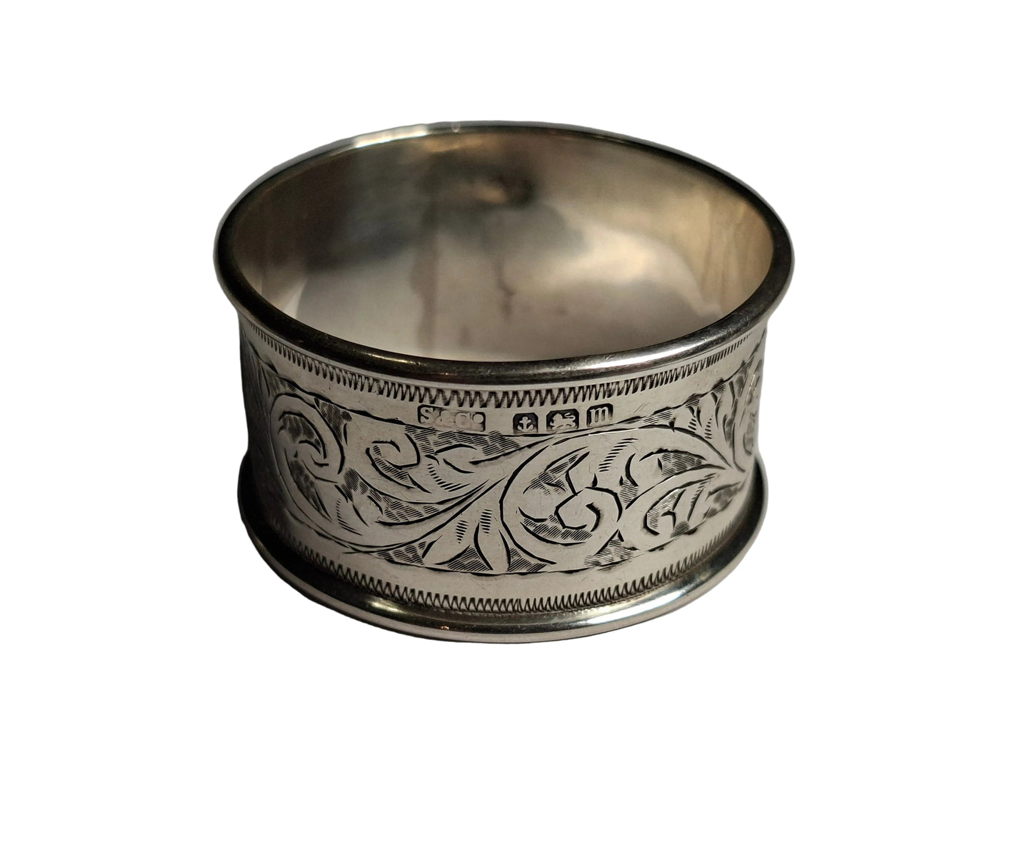 set of three antique silver napkin rings, including examples hallmarked Birmingham 1911 and Chester 1913, along with a third piece with rubbed hallmarks.