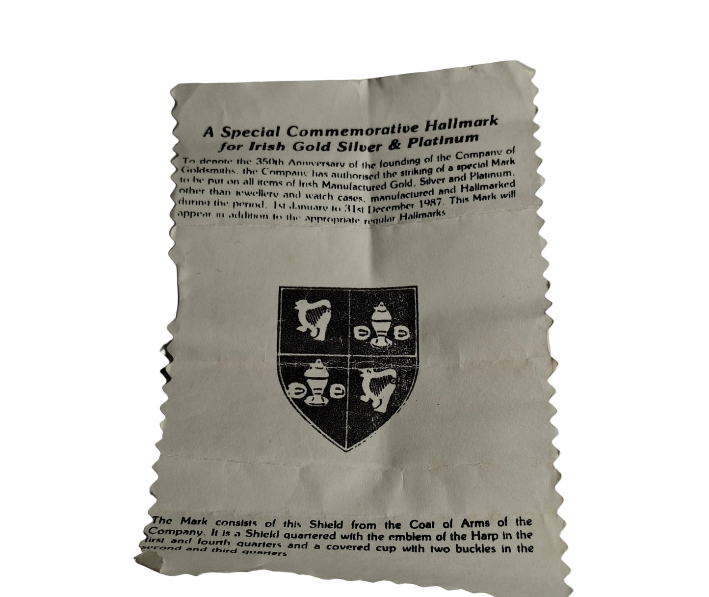 Paper with text and a coat of arms on a gray background