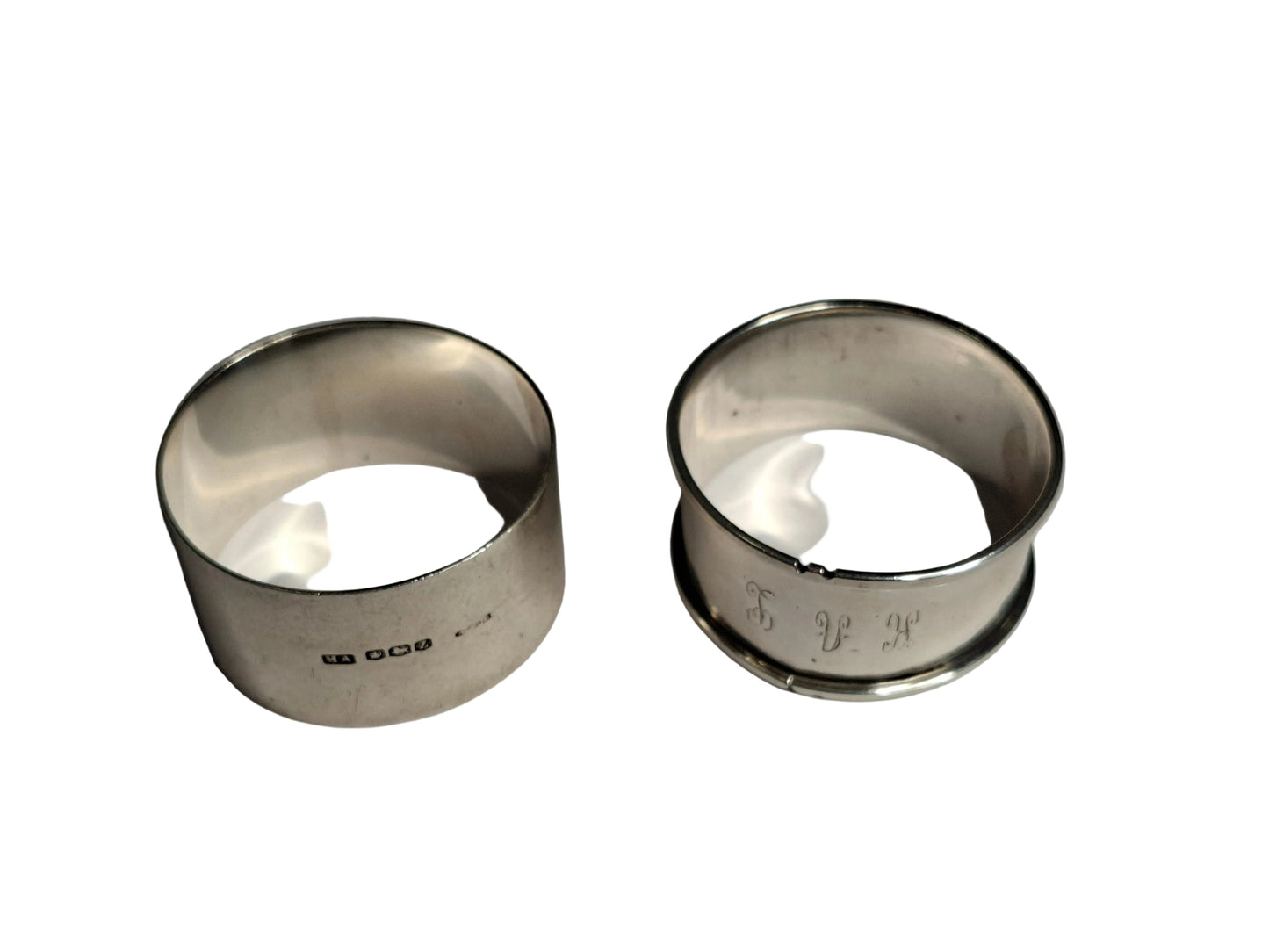 Two antique sterling silver napkin rings, showcasing English craftsmanship from two notable periods. The first is hallmarked Sheffield, 1942, weighing 30 grams