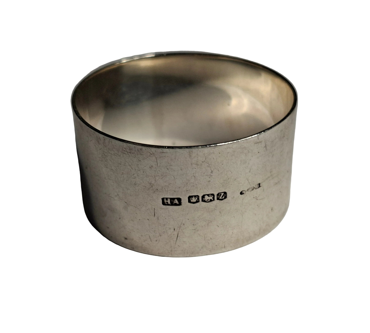 antique sterling silver napkin rings, showcasing English craftsmanship from two notable periods. The first is hallmarked Sheffield, 1942, weighing 30 grams